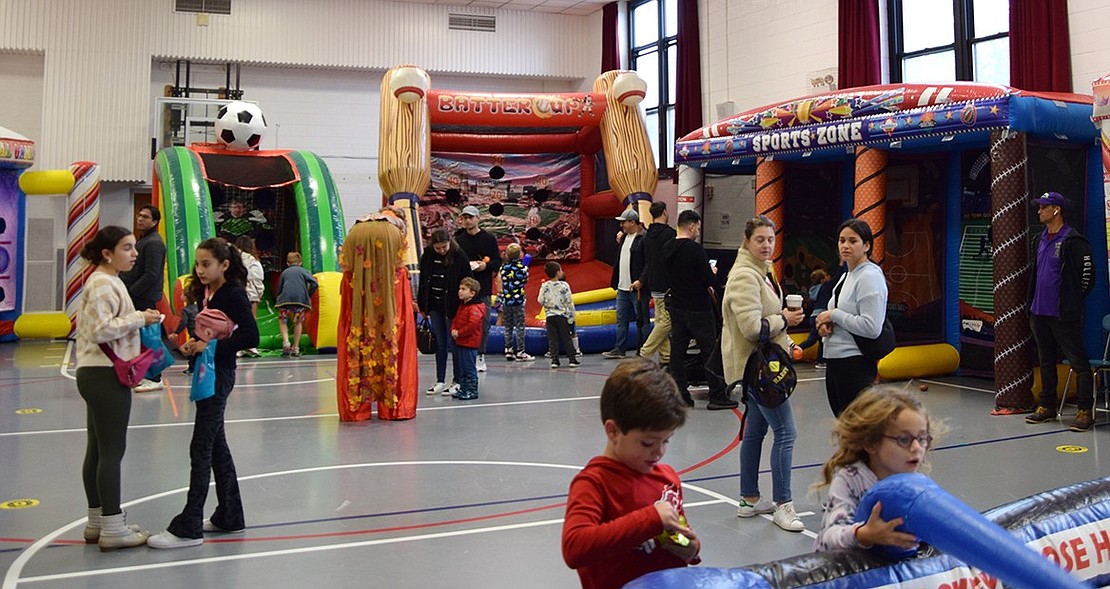 Inflatable attractions line one of the gymnasiums at Ridge Street School, and kids took turns enjoying them all.