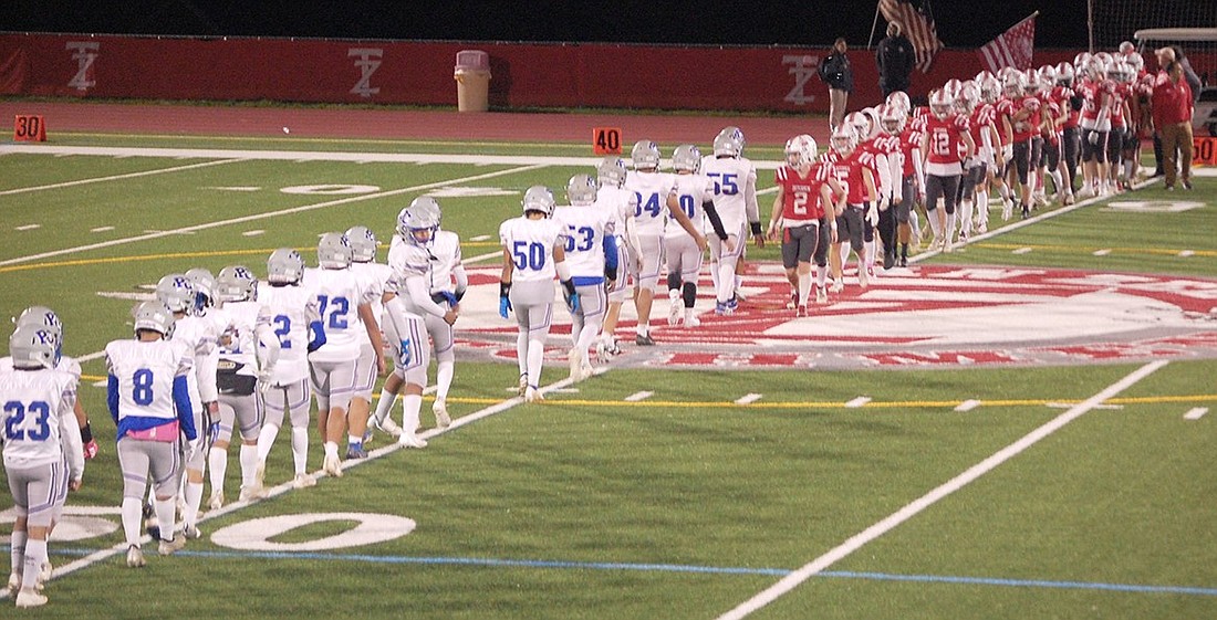 The Port Chester football team shakes hands with their Tappan Zee opponents at the end of a disheartening game which the Rams lost 40-0 under the Friday night lights on the Flying Dutchmen’s turf on Oct. 13.