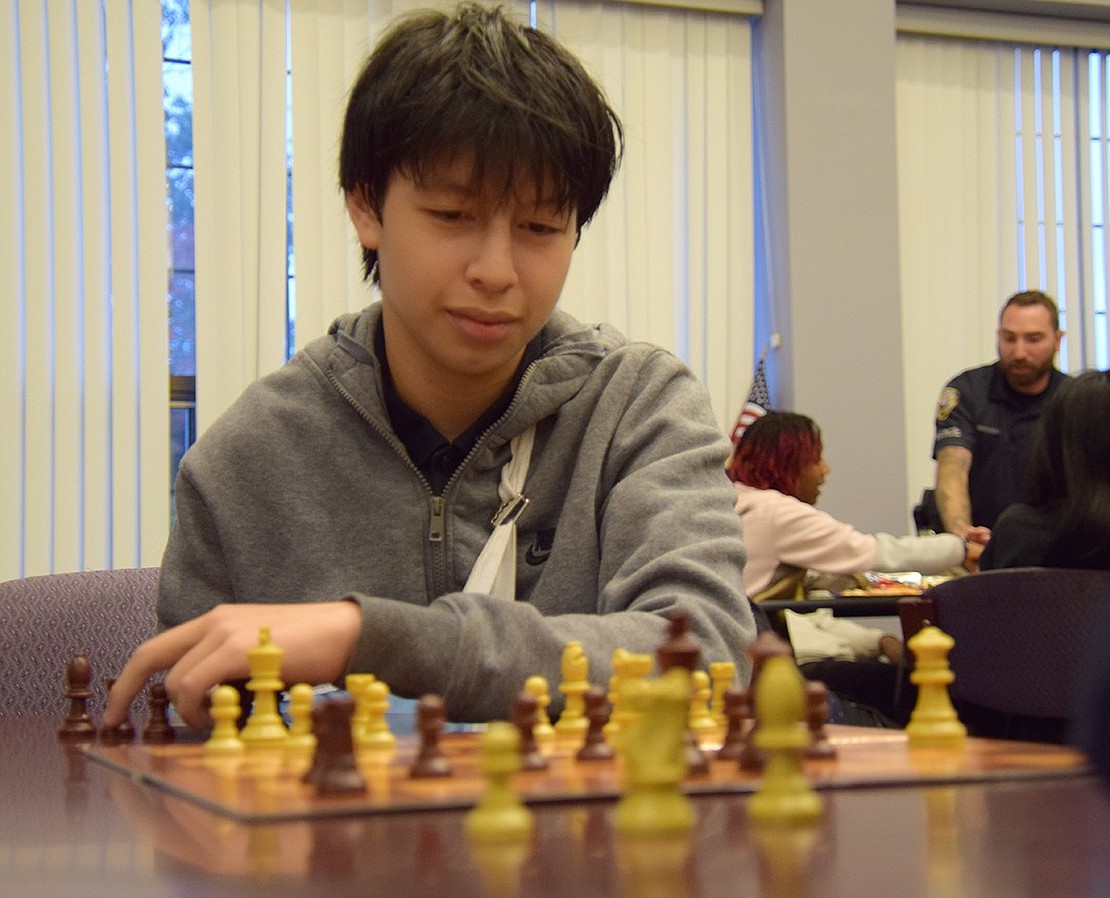 Port Chester Middle School eighth-grader Henry Ramirez contemplates his next move.