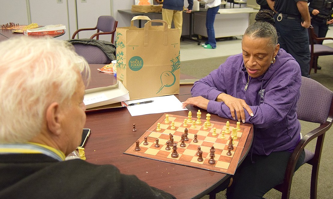 Sharon Castleberry, an employee of the Port Chester Youth Bureau, tries her hand against Grandpas United member Anthony Caracciolo.