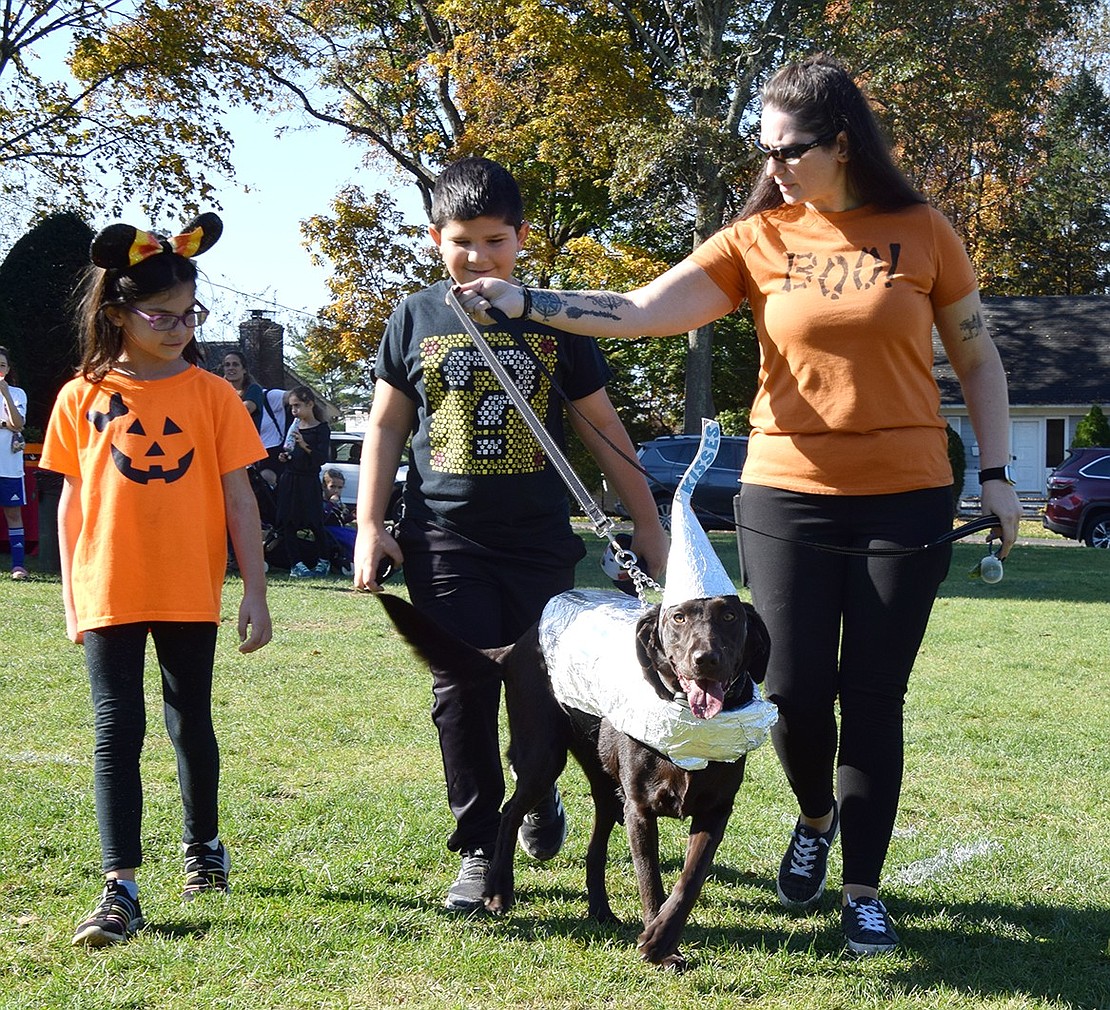 Rye Brook resident Nicole Webber shows off her 3-year-old chocolate Labrador, whose Hershey Kiss costume ended the day in second place in the event which was co-hosted by the Village of Rye Brook and the Humane Society of Westchester.