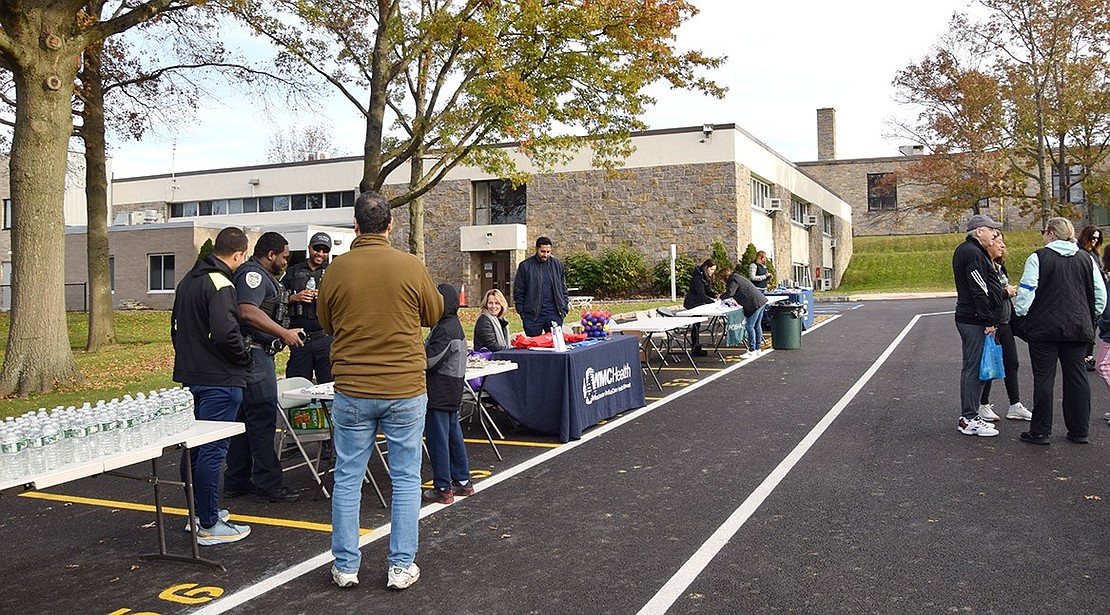 At tables in the parking lot, sponsors give out water, protein bars, and even test attendees’ blood pressure to promote healthy and safe walking habits.