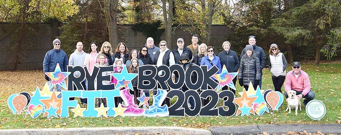 Participants pose for a photo in front of the event signage before embarking on their long morning trek billed as the Rye Brook Fitness Initiative Together (F.I.T.) Community Walk. On the morning of Saturday, Nov. 4, walking enthusiasts met at Ridge Street School for the semi-regular event.