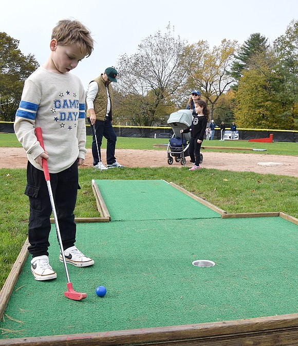 Rye Brook resident Lucas Schwartz, 5, ponders his next shot carefully.