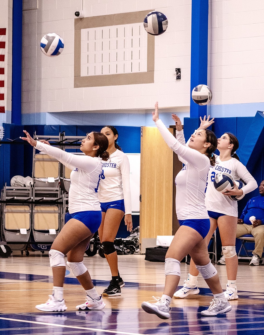 Members of the Port Chester High School volleyball team warm up for a game during the fall season.