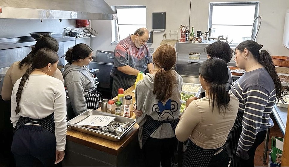 Local teen Girl Scouts assisted Knight Charles Sacco, who is in charge of the kitchen at the Port Chester Knights of Columbus hall, with the food preparation and serving at the Veterans Thank You Lunch on Saturday, Nov. 4.