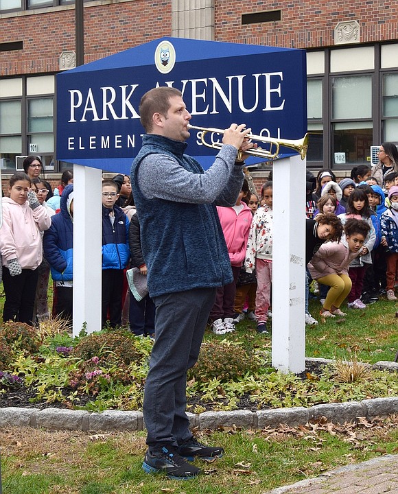Park Avenue School music teacher Michael Johnson plays his rendition of Taps to honor the veterans who have passed away.