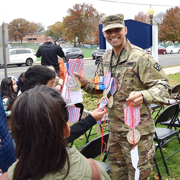 Joao Cardoso, a resident of Perry Avenue and current U.S. Army reservist, smiles after receiving several handmade medals from Park Avenue School students Thursday, Nov. 9. The school held a Veterans Day ceremony that morning to honor those who have served in the U.S. military.