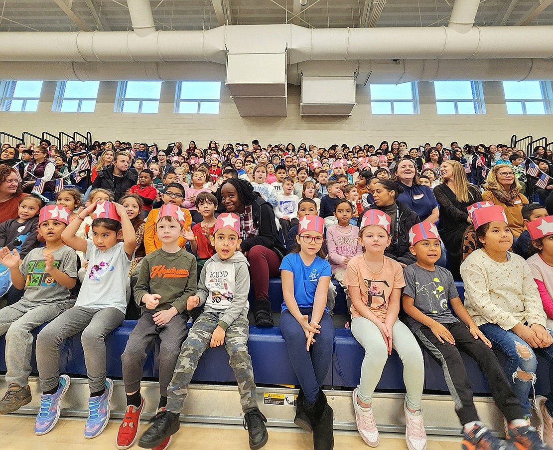 King Street School students sit on the bleachers of the gymnasium donning patriotic crafts on their heads while honoring the veterans in attendance during their school’s ceremony on the morning of Thursday, Nov. 9.