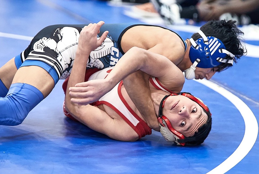 Nicholas Bolanos (on top), a four-time All-Section wrestler for the Rams who graduated with more than 100 career wins and is now a sophomore at Manhattanville College, is a new volunteer wrestling coach at Port Chester High School.