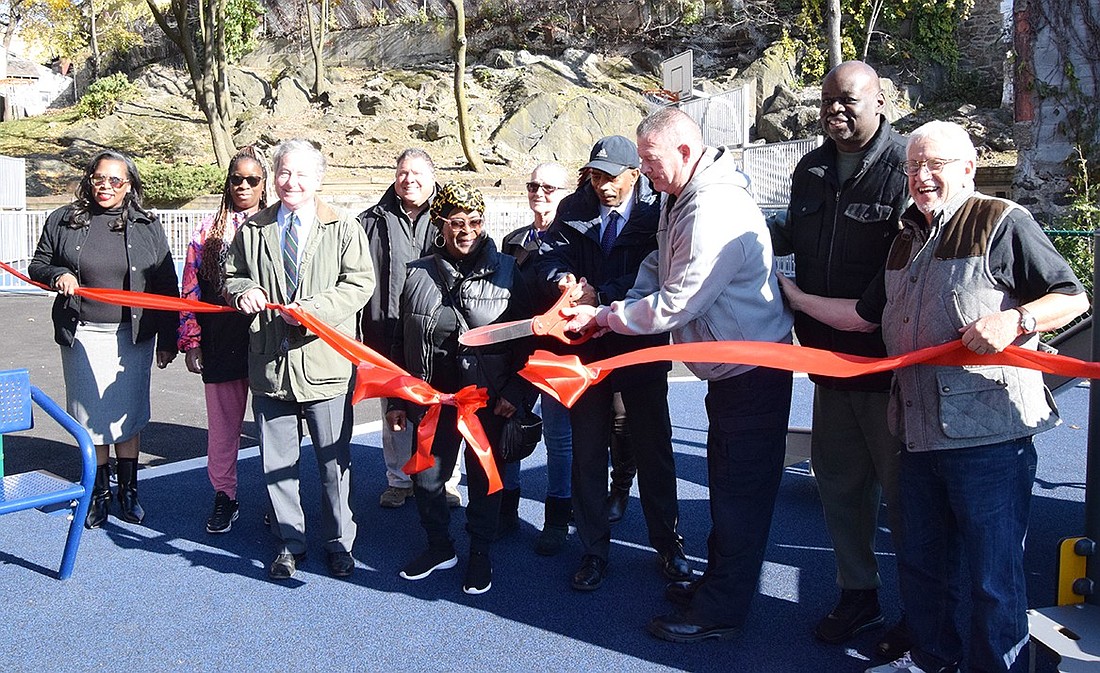 Members of the Port Chester Housing Authority cut a ribbon to formally open the newly constructed playground and basketball court at the rear of 45 Traverse Ave. on Thursday, Nov. 16.