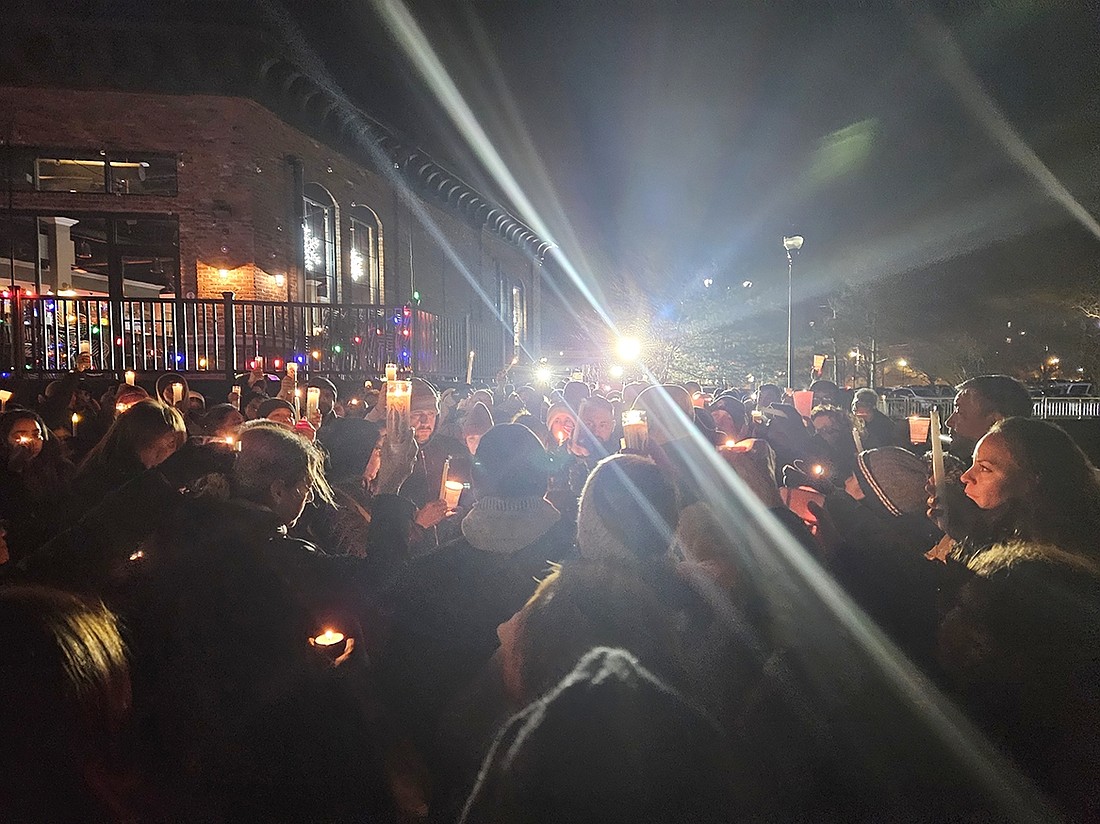 Nearly 100 people gather on Monday, Nov. 27, for a vigil honoring Jan Carlo Yepes, the West Harrison man who was found dead after a three-day search. The vigil, organized by the Yepes family and the Village of Port Chester, took place at the marina behind Colony Pizza, near where his body was recovered.