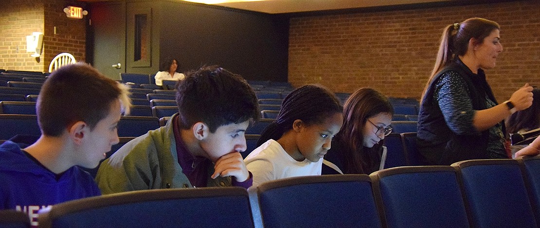 As the rehearsal goes on, members of the middle school tech crew Louis Rytelewski (left), Diego Quezada, Jaslin Dapaah and Kylie Omera watch carefully and take notes on how to improve the performance.