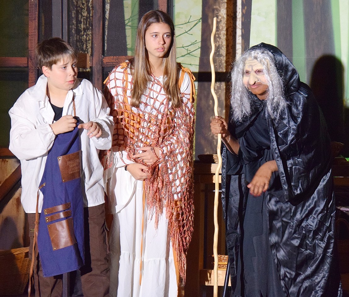 The baker (left), played by Alexander Tamucci, and his wife, portrayed by Sophia Berlingo, question the witch who cursed their family. Under the witch’s mask and wig is Antonia Rieke.