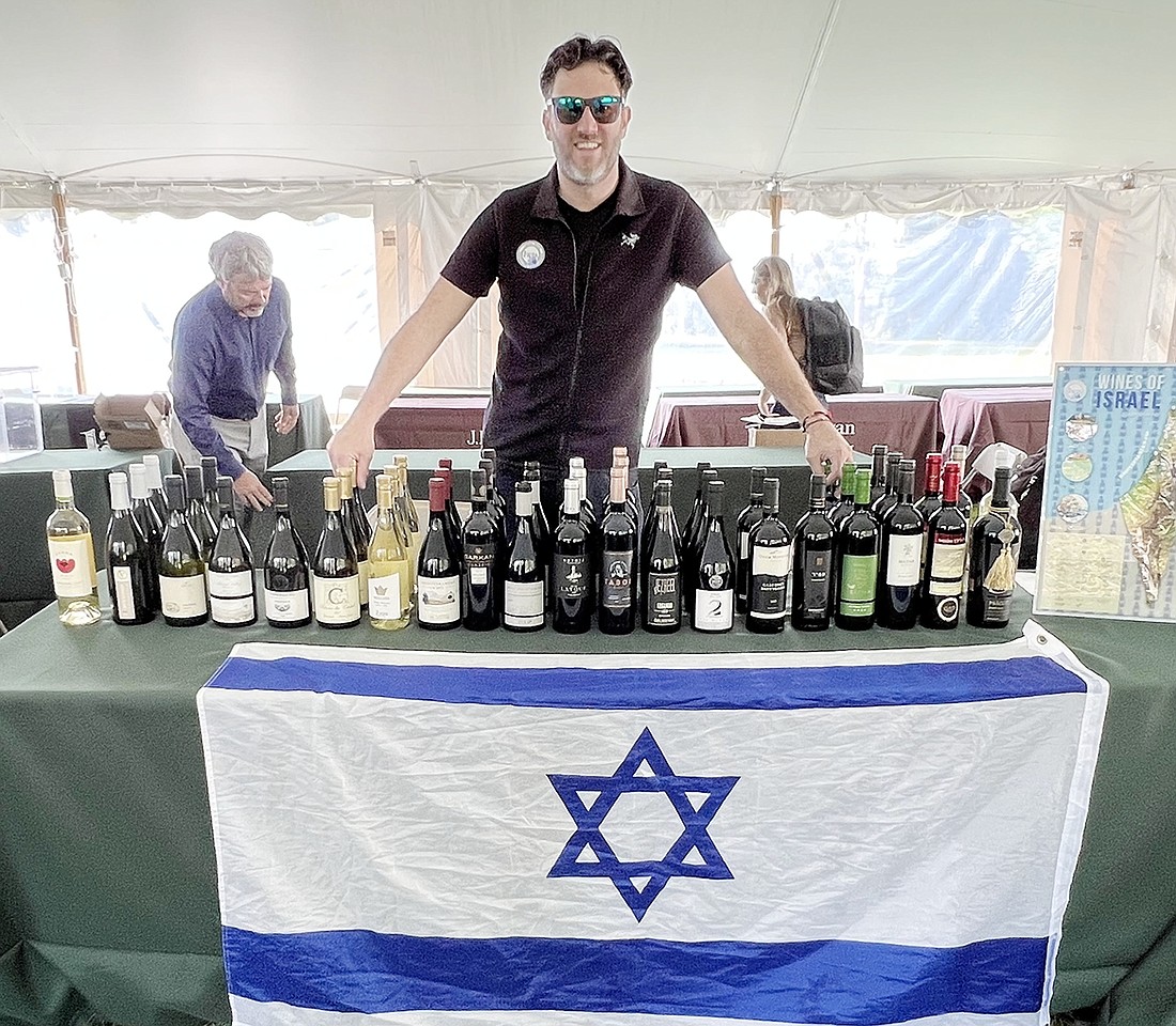 Joshua Greenstein, VP of IWPA, displays some of the Israeli wines available during Sip for Solidarity.