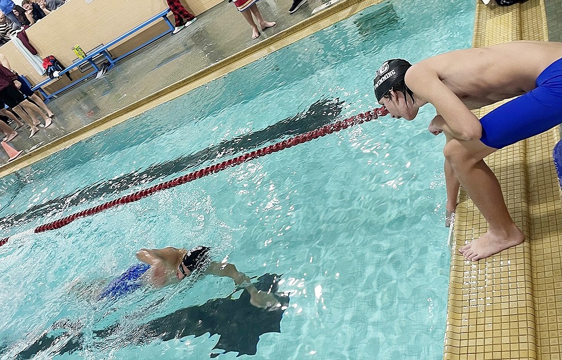 Tiernan McLoughlin counts the 20 laps of Santiago Marquez not only winning the 500-yard freestyle but breaking the school record in this event during the Port Chester Rams’ opening away meet against Harrison Monday (12/4).