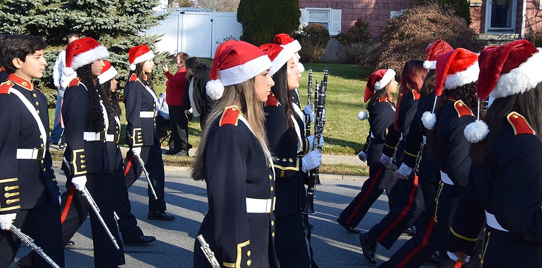 Pride of Port Chester marchers don festive Santa hats while elegantly keeping in line as they proceed down King Street for the Christmas Parade.