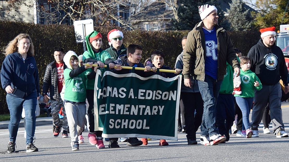 Led by Principal Paul Roncagliolo, Edison Elementary School students, families and staff proudly represent their building in the holiday procession.