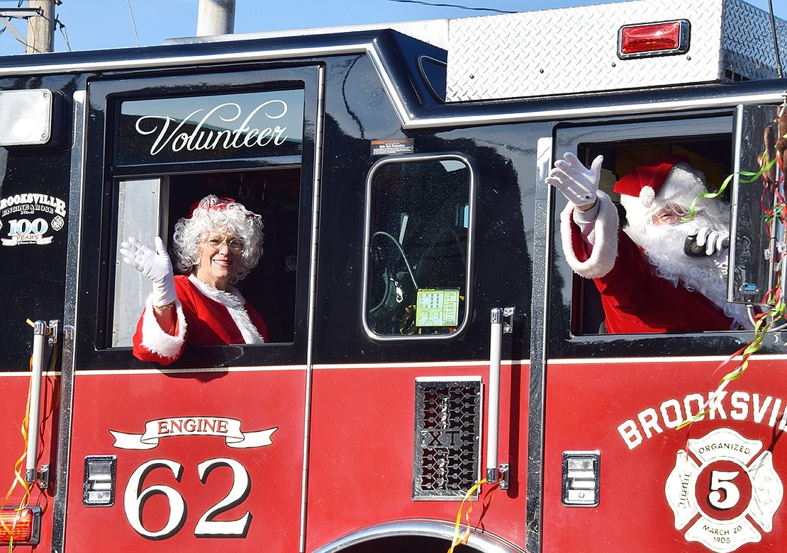 Making a grand entrance in a Brooksville Engine & Hose truck, Mrs. Claus and Santa forgo the sled and reindeer to arrive at Lyon Park in Port Chester style.