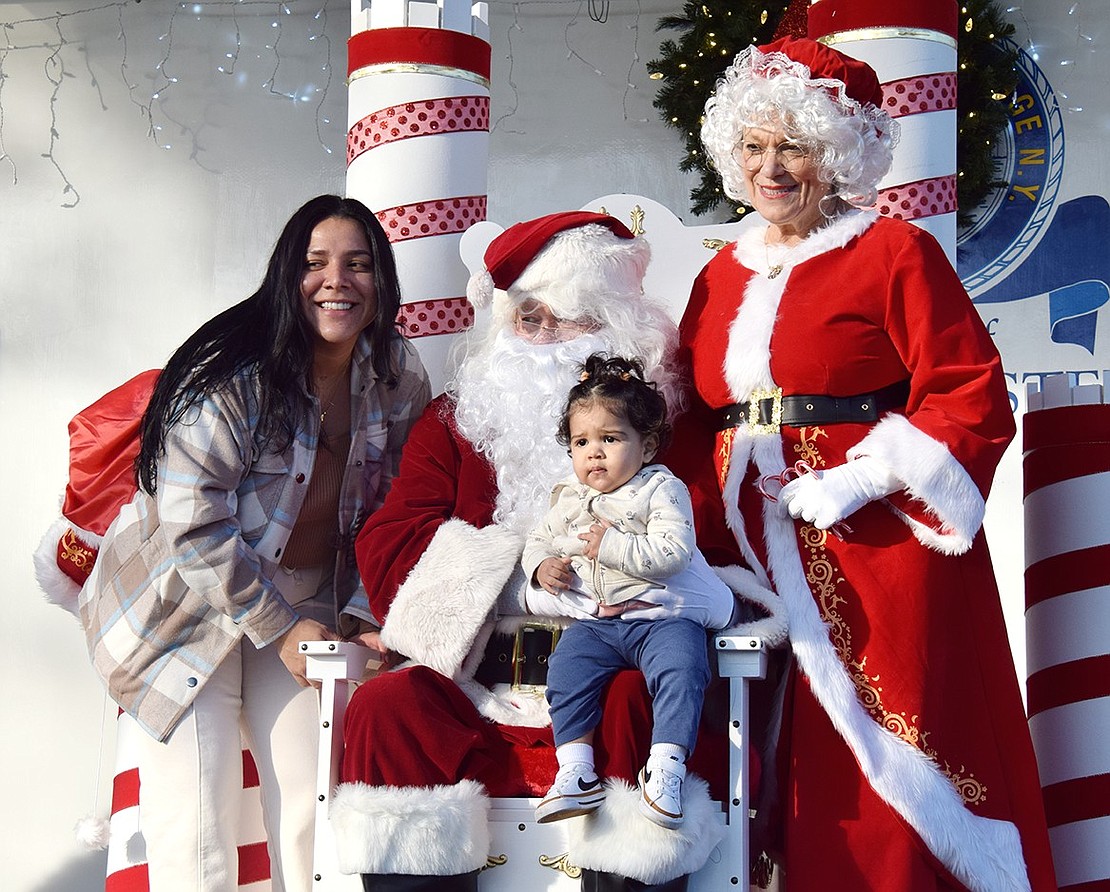 Though 14-month-old Mia Sandoval looks a little concerned, she’s making memories that will last a lifetime by meeting Santa and Mrs. Claus (who secretly live double lives as Steve Carroll and Hope Vespia) with her mother Tatiana Liberio. The Smith Street residents joined hundreds of others in Lyon Park on Saturday, Dec. 9, to celebrate the holidays during Port Chester’s annual Christmas Parade and Santa in the Park event.