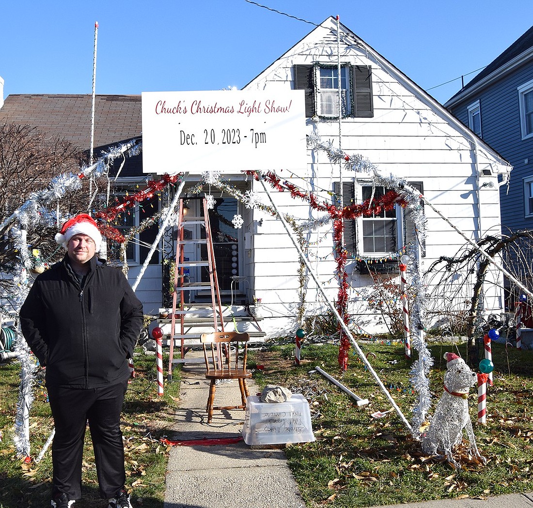 Charles “Chuck” Lauria poses for the camera in front of his home at 135 Fairview Ave. He’s hard at work preparing for a Christmas light show, which will take place on Wednesday, Dec. 20 at 7 p.m.