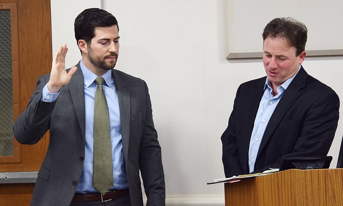 Dan Bruno (left) gets sworn in by Rye Brook Mayor Jason Klein as he’s promoted to sergeant in the Rye Brook Police Department on Tuesday, Dec. 12 at Rye Brook Village Hall during a Board of Trustees meeting.