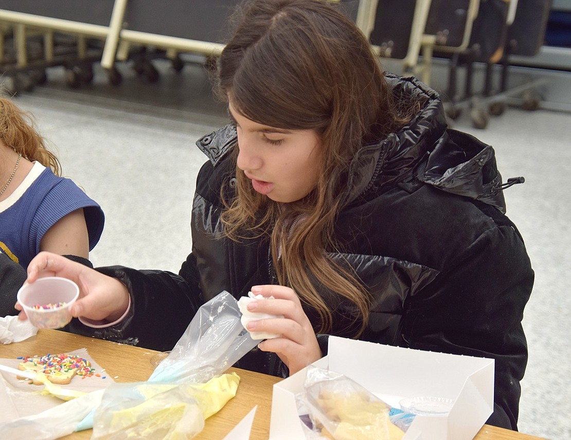 Oops! Fourth-grader Roxanna Zacharoulis accidentally spills too many sprinkles on her freshly frosted cookie. But that’s OK, a little extra color has never hurt anybody.