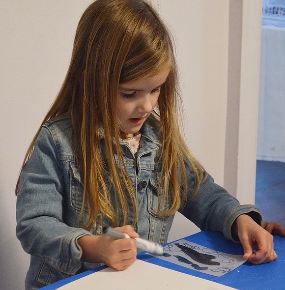 Everleigh Higgs, 5, of Puritan Drive decorates a Shrinky Dink holiday ornament that will be transformed when taken home and heated in the oven.