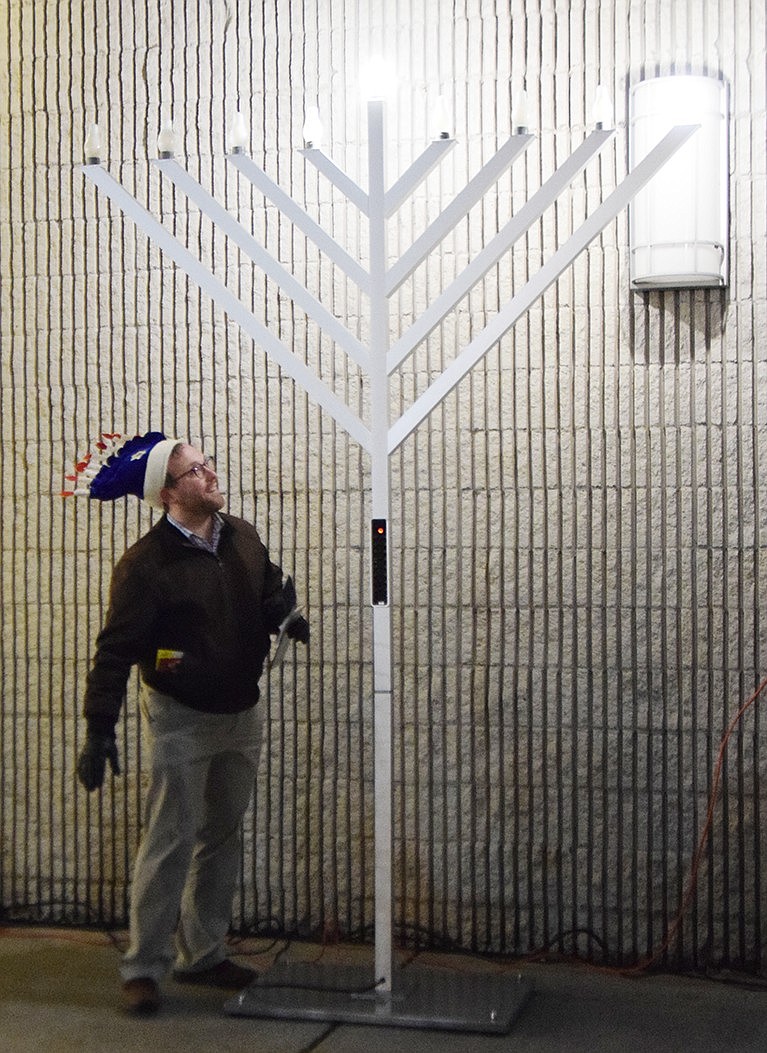 Rabbi Ben Goldberg of Congregation KTI in Port Chester looks up at the menorah in the courtyard at the Gateway Shopping Center after it was lit on the first night of Hanukkah—Thursday, Dec. 7—during a celebration to welcome the Jewish Festival of Lights co-sponsored by the Port Chester-Rye Town-Rye Brook Chamber of Commerce and the Village of Port Chester. Following darkness there will be light was the theme of the celebration.