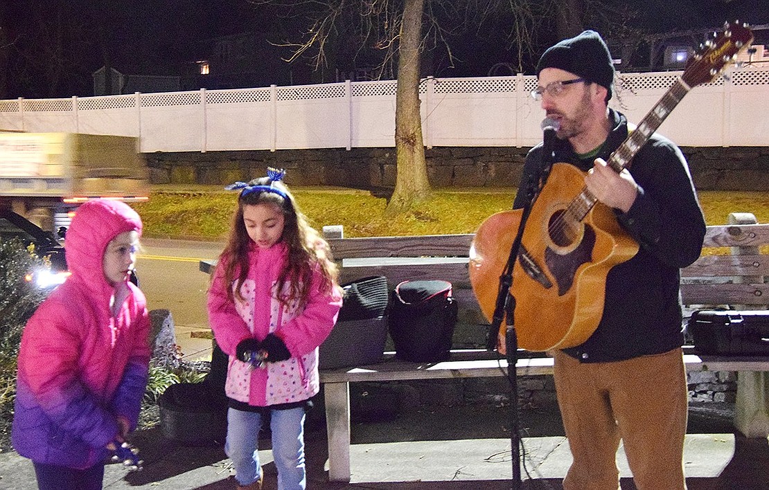 Ringing bells along to the tunes, Port Chester residents Ryan Allen (left), 7, and Sophia Labrusciano, 8, join New Rochelle-based children’s musician Zev Haber for a performance.