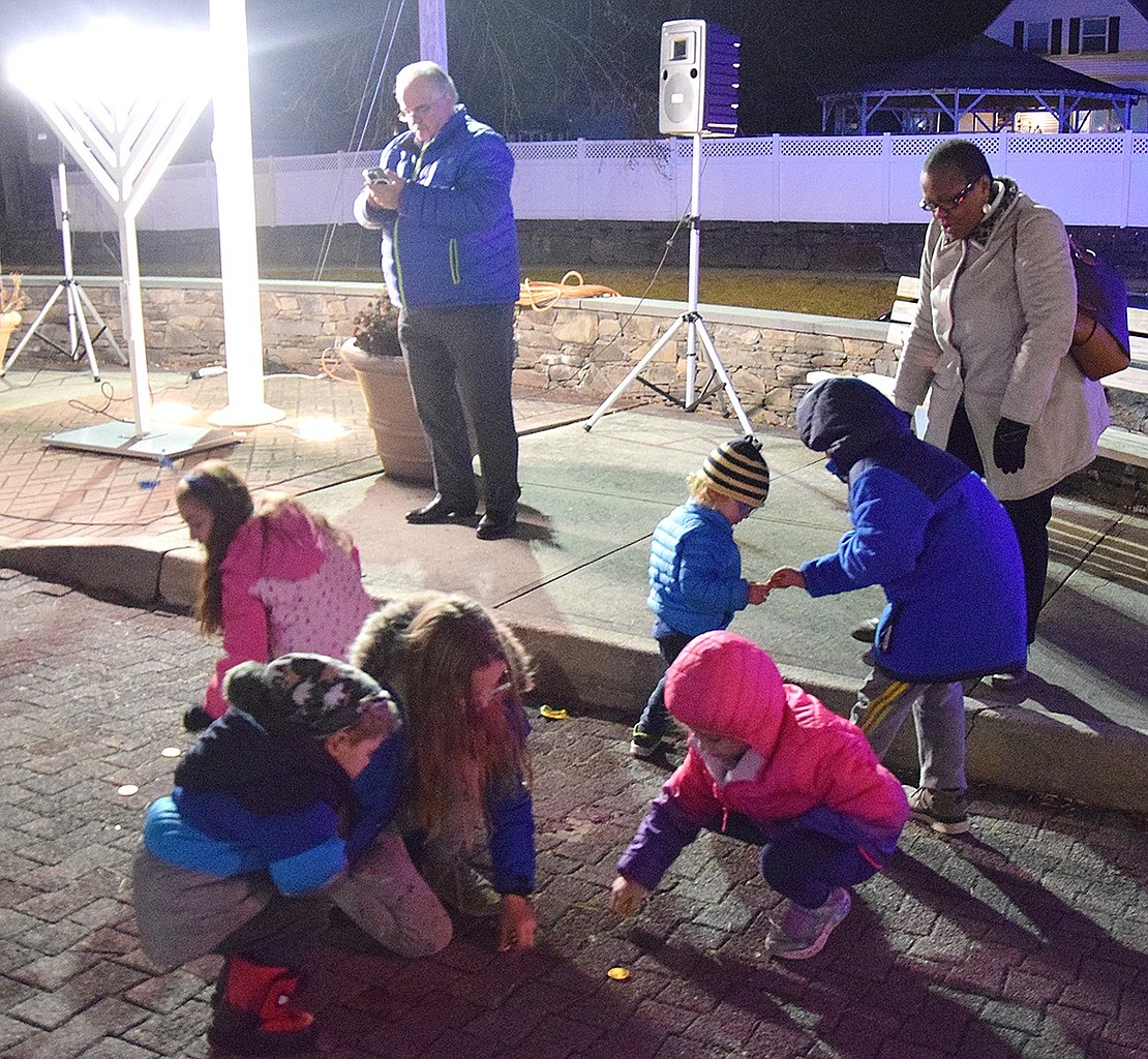 With the chocolate coins raining down, Port Chester Trustee Phil Dorazio (not pictured) joked “One of them is real gold,” as the kids rushed to collect as many sweets as they could carry.