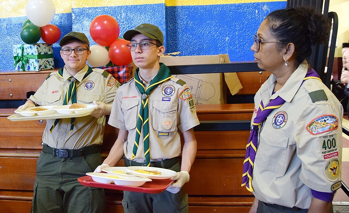 BSA Troop 400 Scouts Christopher Colby and Julian Cavallino, respectively from Rye Brook and Port Chester, await direction from Dona Ortiz, scoutmaster of the all-girls BSA Girl Troop 420.