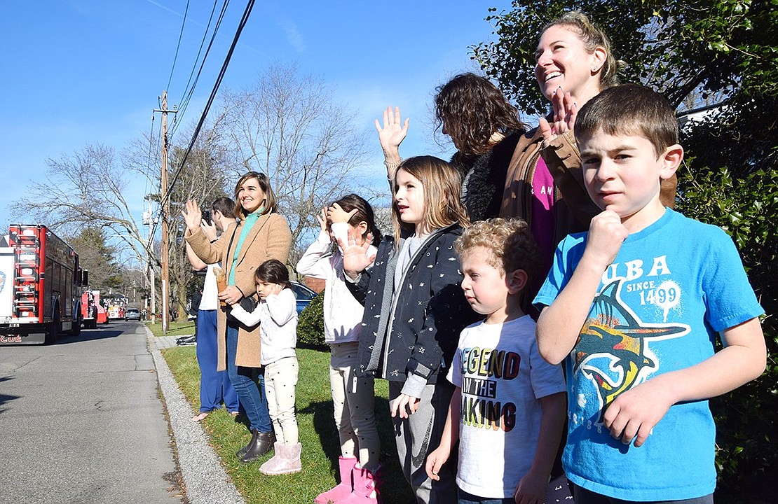 Spencer Scheer (right), 6, and his 3-year-old brother Eli are joined by other Rye Brook families, the Andruks and Zangbars, on Rock Ridge Drive to catch a glimpse of Jolly Old Saint Nicholas.