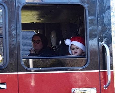 James Oxer, of Greenwich, Conn., rides on Ladder 31 of the Harry Howard Hook & Ladder Company. Oxer is a great-grandson of former Port Chester Fire Department Captain George Oxer, who died in 2014.