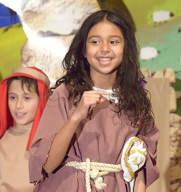 In the opening number “Bethlehem is Busy,” ensemble member Mila Torres, a third-grader, flashes a bright smile to the audience while she dances.