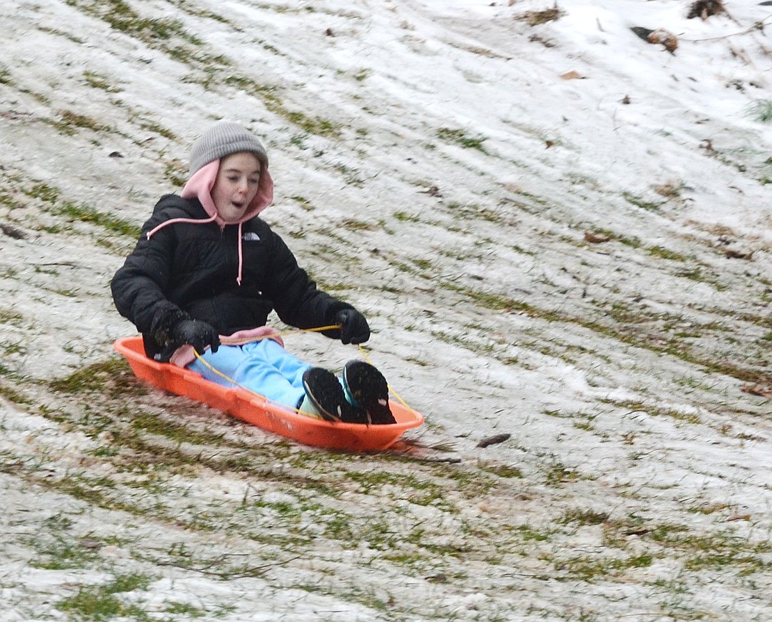 Eleven-year-old Harper Grant of Country Ridge Drive slides down the hill with ease.