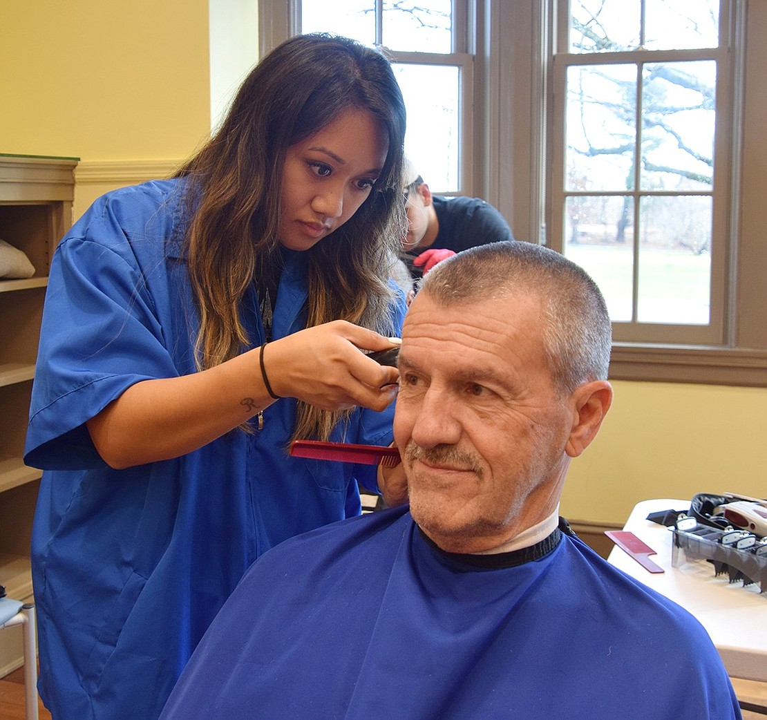 Jennifer Brooks, a student at the Westchester Barber Academy from New Windsor, gives Rye Town Director of Parks and Facilities Vic Federico a trim.