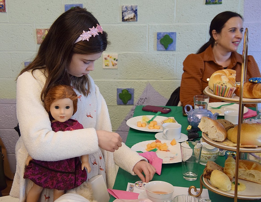 Penelope Magliacca, an 8-year-old who lives on Holly Lane, makes a friendship bracelet with her doll Blaire at the “My Doll and Me Tea” fundraiser hosted by the Port Chester/Rye Brook Girl Scouts. The tea party, held on Sunday, Jan. 14, at the Girl Scout House in Lyon Park, raised money for the organization’s Scholarship Fund, which benefits girls who finish high school as active members of the Scouts.