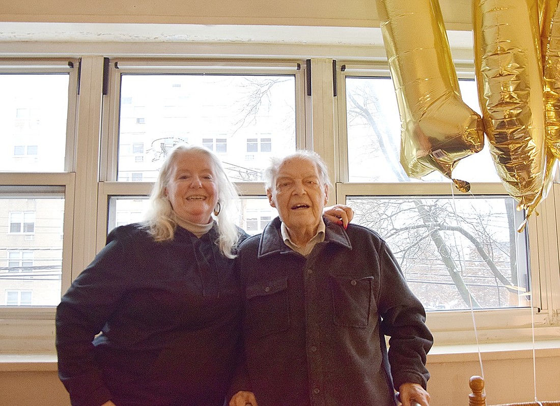 Lory Kelsey and her father Morley Jewell pose with balloons commemorating his centennial on Tuesday, Jan. 16, in his apartment on Westchester Avenue. A resident of Port Chester for more than half a century, Jewell celebrated his 100th birthday on Jan. 14.