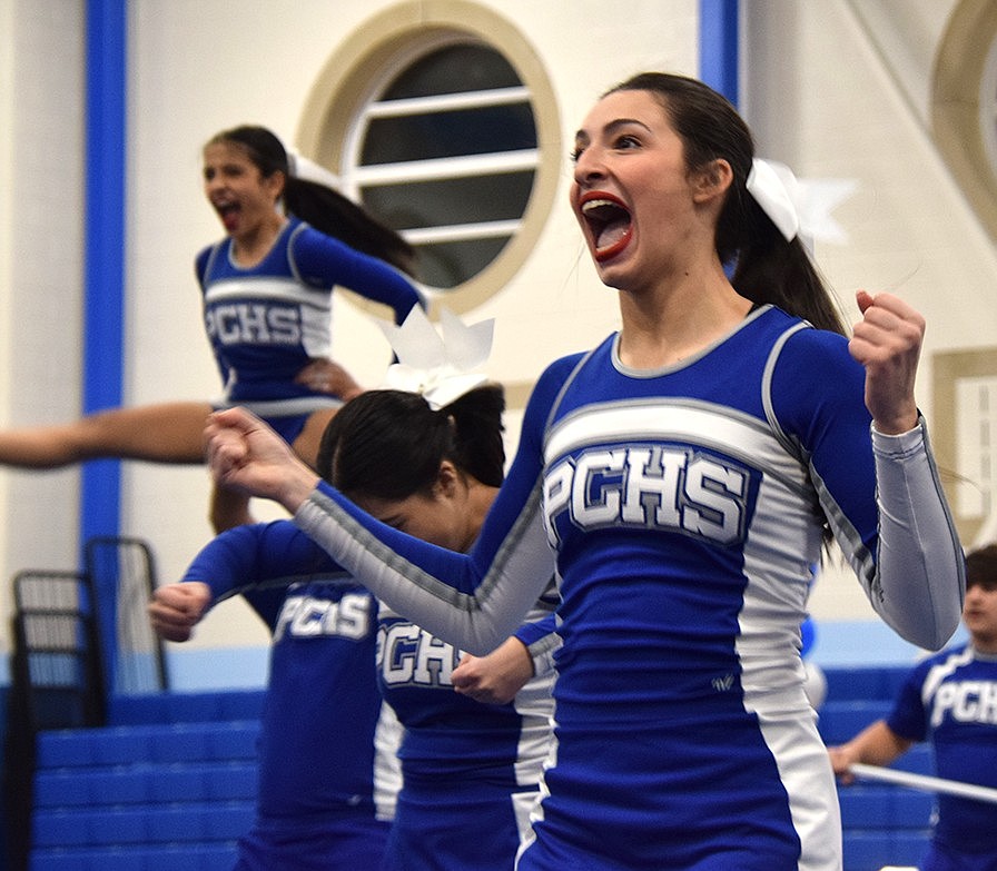 With the energy showing on her face, Mia Pagnotta, a junior on the varsity team, gets pumped up during one of their cheer routines.