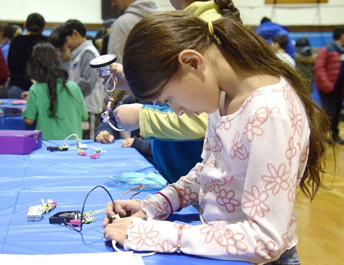 With meticulous precision, third-grader Natalie Datino stays focused and steady while creating a circuit at one of nearly two dozen tables set up around the Port Chester High School old gym on Thursday, Feb. 1. The Park Avenue Elementary School student was exploring the district’s second annual STEAM Fest event along with other third- through fifth-graders district-wide.