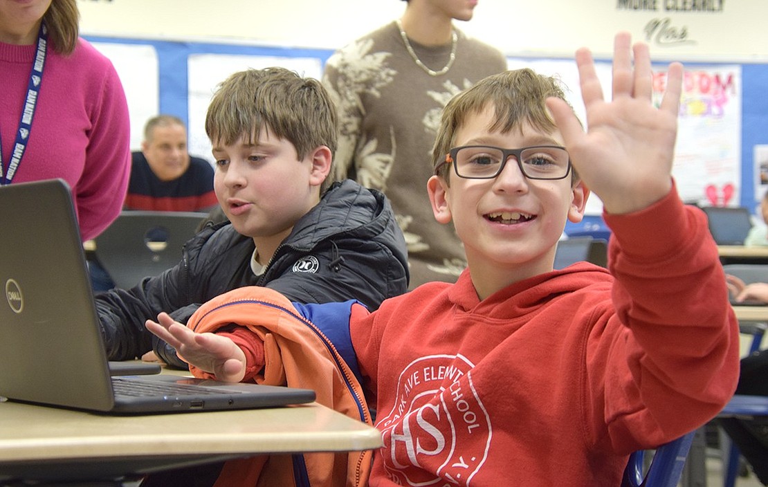 Park Avenue Elementary School fourth-grader Bradyn Tamucci (right) takes a quick break from playing an A.I. music game with his brother Alexander to say, “what’s up.” Alexander is a sixth-grader at Port Chester Middle School.