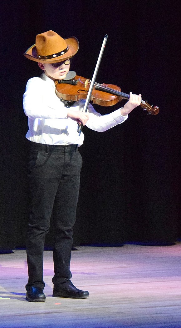 Inspired to play the violin by his grandfather, Ridge Street School third-grader Jacob Koyfman gets the audience to clap along.