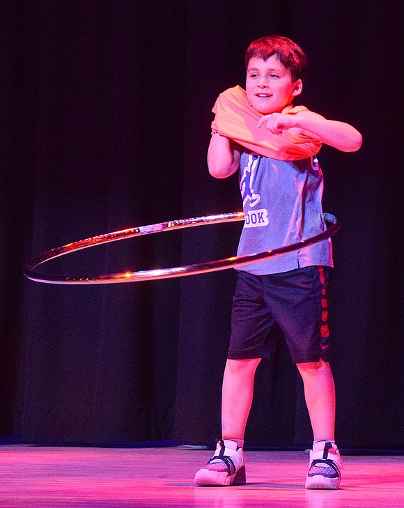 To demonstrate his mastery of the skill, second-grader Jack Goldman takes off one of his shirts as he hula hoops.