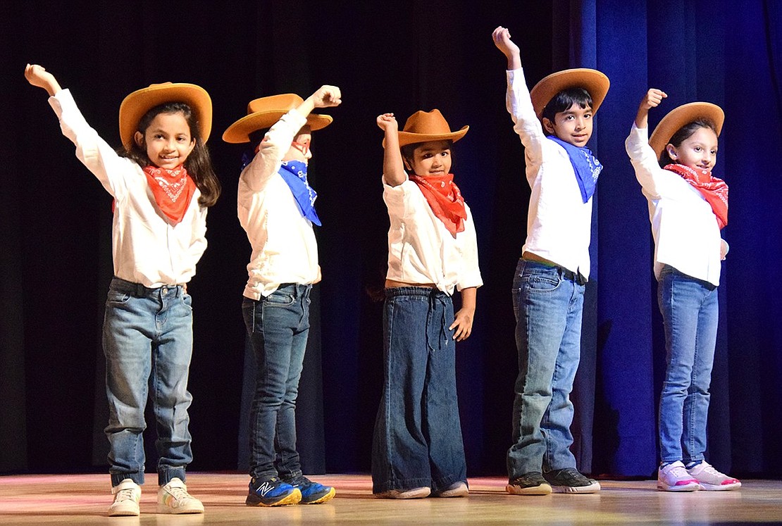 Members of “The Funky Friends,” a group of Ridge Street students ranging from kindergarten to second grade, perform a line dance.