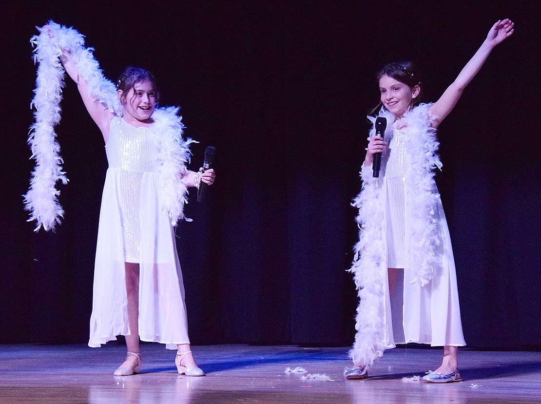 Morgan Sontag (left) and Nicole Lucca conclude their act as “The Diamond Duo.” The fourth-graders wore shiny dresses for their rendition of “Diamonds” by Rihanna.