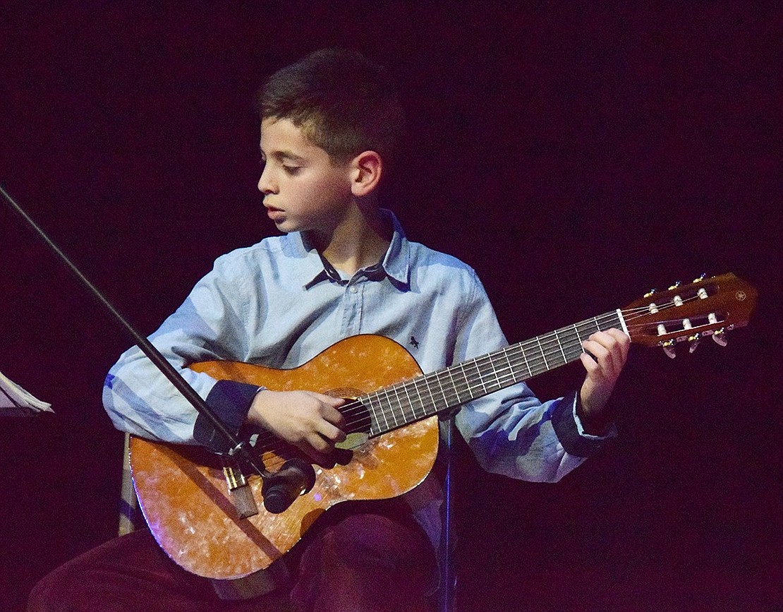 Anthony Gebrael, a fourth-grader at Ridge Street School, shows off his classical guitar skills.