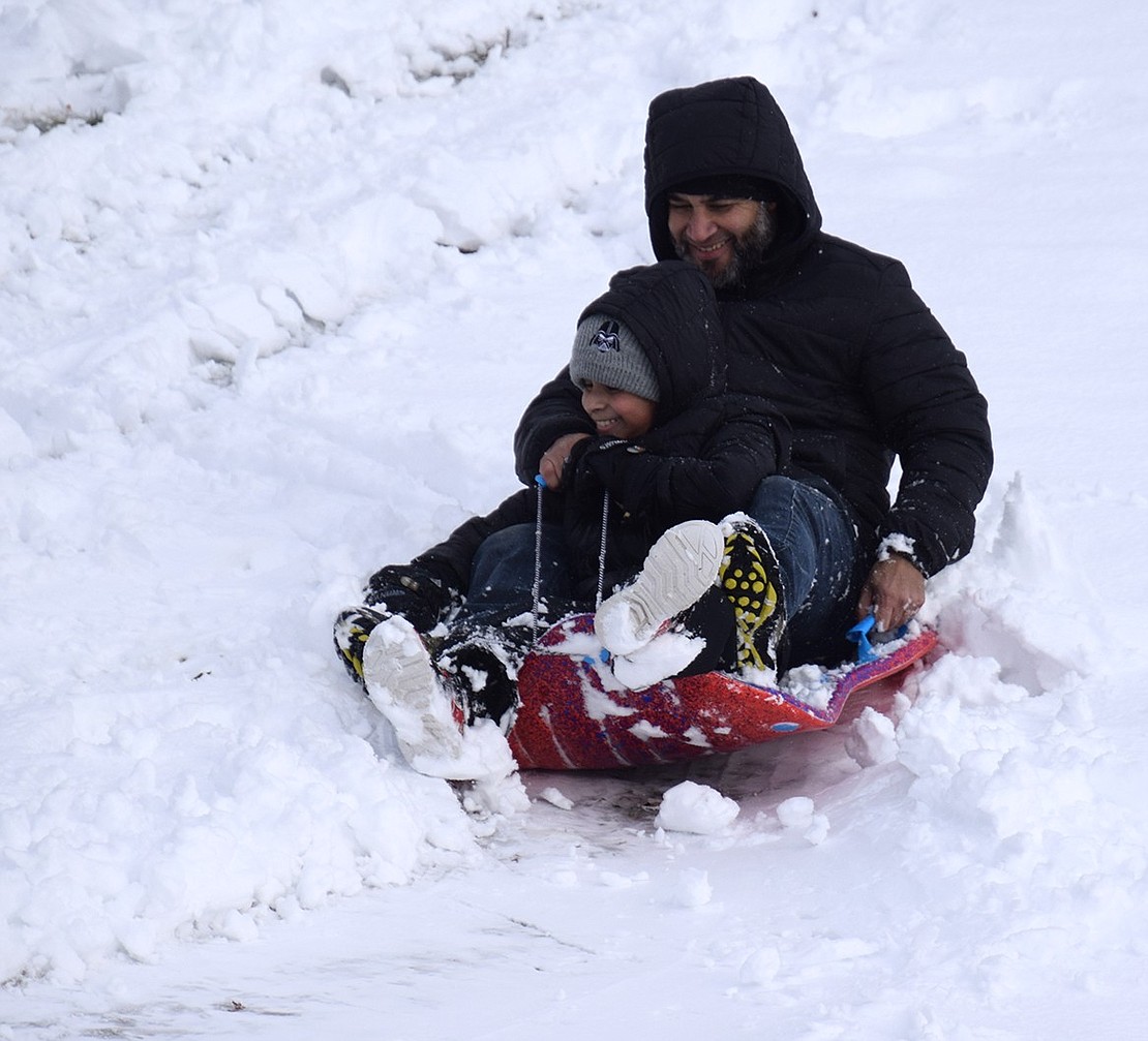 Lucas Mejia and his 8-year-old son Christian of Riverdale Avenue have a ball in the snow at Rec Park—from sledding, to throwing snow at each other, to making snow angels.