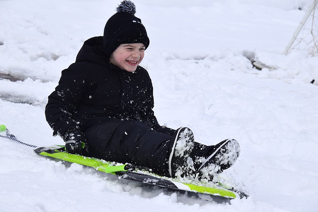 Six-year-old Gino Patafio of Brower Place slides down one of the many hills children and adults used for sledding at Recreation Park on Locust Avenue Tuesday afternoon, Feb. 13, after about five inches of snow fell steadily starting in the early morning in Port Chester and Rye Brook, cancelling school.