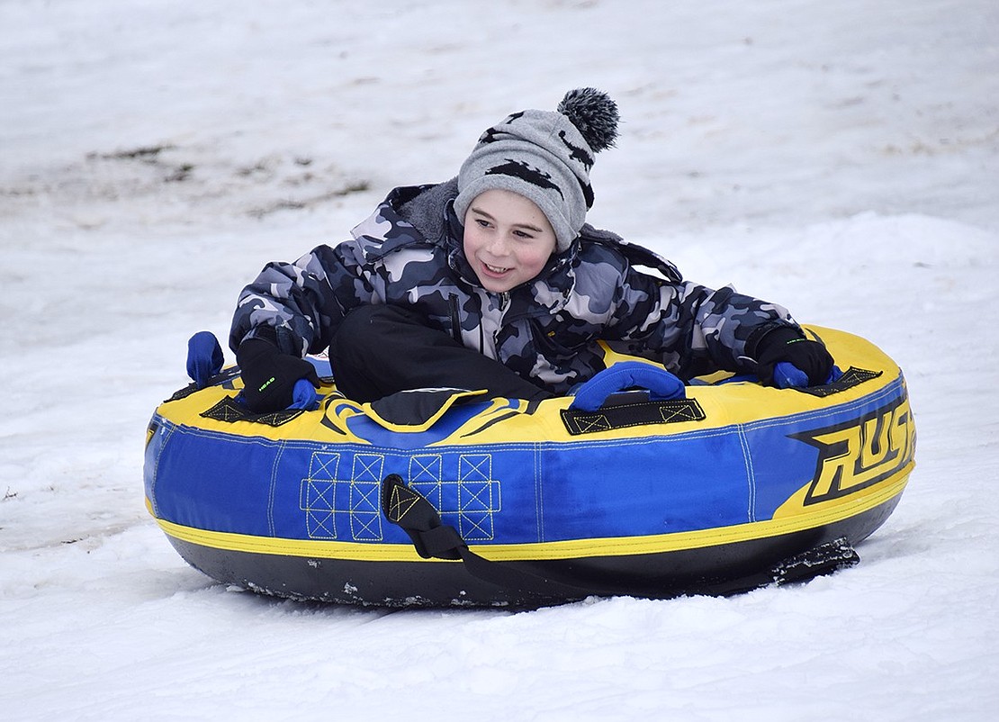 Three-year-old Eli Sheer of Concord Place charges down the hill on the Lincoln Avenue side of Crawford Park in a tube Tuesday afternoon, Feb. 13, after about five inches of snow fell steadily starting in the early morning in Port Chester and Rye Brook, cancelling school.